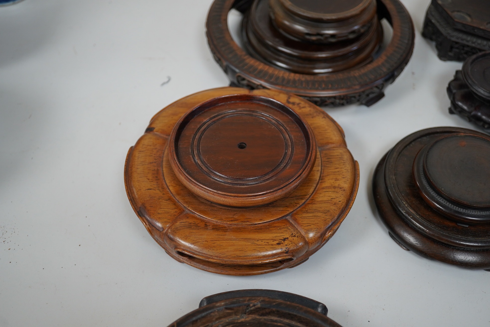 A group of 19th century and later Chinese hardwood stands, largest 18cm in diameter. Condition - mostly fair to good